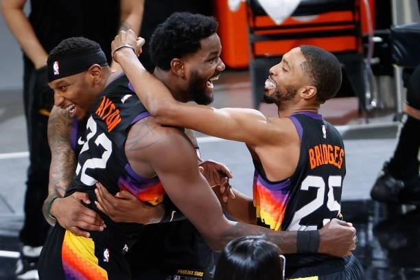 Deandre Ayton of the Phoenix Suns celebrates with Torrey Craig and Mikal Bridges after a last second slam dunk against the LA Clippers in game two of...