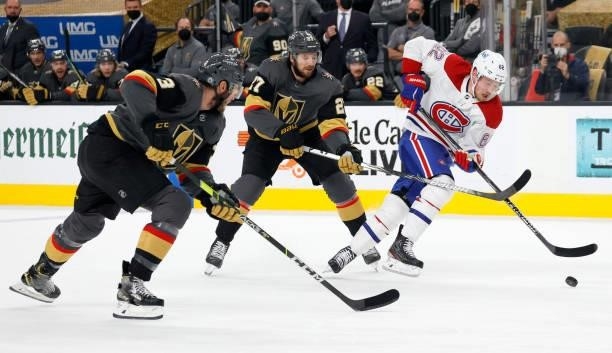 Artturi Lehkonen of the Montreal Canadiens skates with the puck ahead of Brayden McNabb and Shea Theodore of the Vegas Golden Knights in the first...