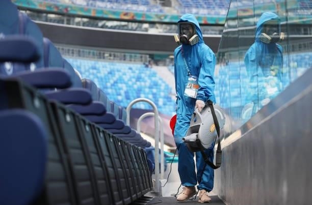 Member of staff disinfects the stadium seats prior to the UEFA Euro 2020 Championship Group E match between Sweden and Poland at Saint Petersburg...