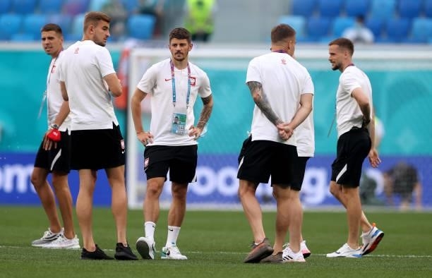 Dawid Kownacki of Poland inspects the pitch with teammates prior to the UEFA Euro 2020 Championship Group E match between Sweden and Poland at Saint...