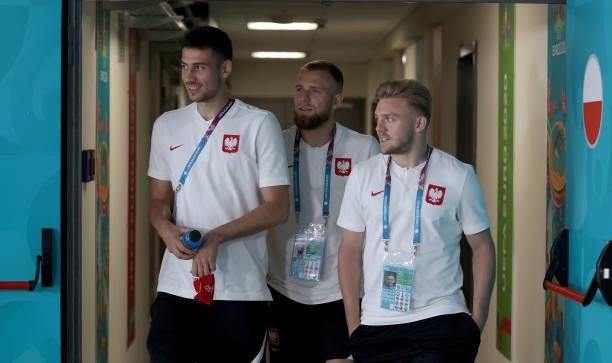 Jakub Moder, Tymoteusz Puchacz and Kamil Jozwiak of Poland walk out to inspect the pitch prior to the UEFA Euro 2020 Championship Group E match...