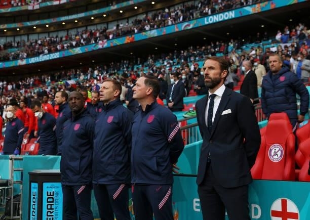 Gareth Southgate, Head Coach of England, Steve Holland, Assistant Manager of England, Graeme Jones and Chris Powell, Coaches of England stand to sing...