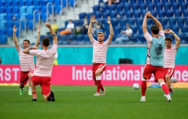 Michal Helik of Poland warms up with teammates prior to the UEFA Euro 2020 Championship Group E match between Sweden and Poland at Saint Petersburg...