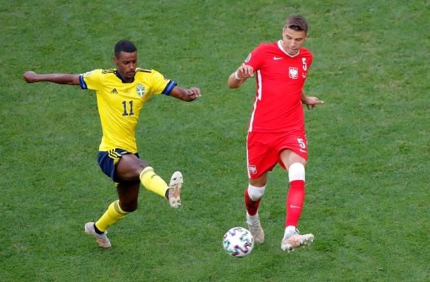 Jan Bednarek of Poland passes the ball whilst under pressure from Alexander Isak of Sweden during the UEFA Euro 2020 Championship Group E match...