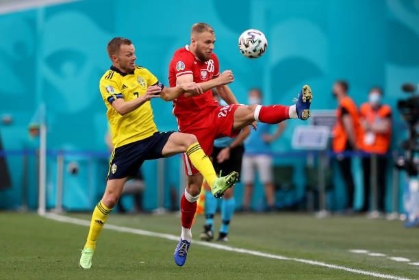 Sebastian Larsson of Sweden battles for possession with Tymoteusz Puchacz of Poland during the UEFA Euro 2020 Championship Group E match between...