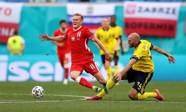 Karol Swiderski of Poland is fouled by Marcus Danielson of Sweden during the UEFA Euro 2020 Championship Group E match between Sweden and Poland at...