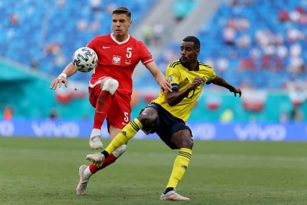 Jan Bednarek of Poland is challenged by Alexander Isak of Sweden during the UEFA Euro 2020 Championship Group E match between Sweden and Poland at...