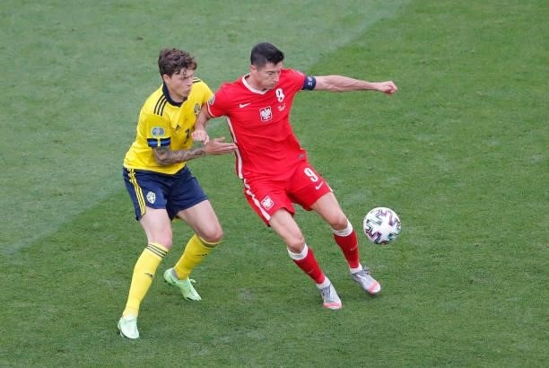 Robert Lewandowski of Poland holds off Victor Lindeloef of Sweden during the UEFA Euro 2020 Championship Group E match between Sweden and Poland at...