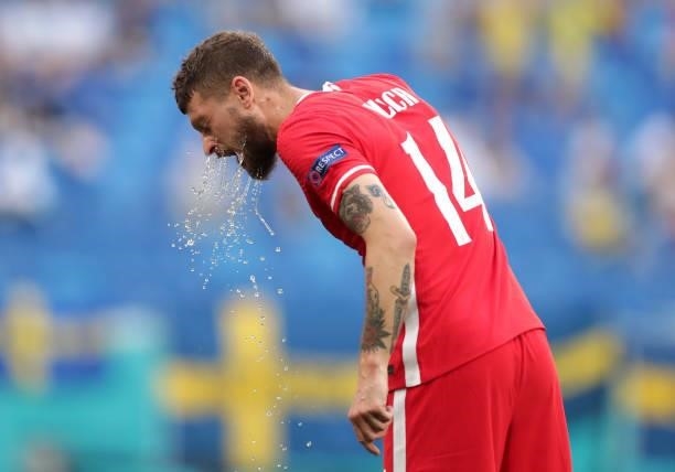 Mateusz Klich of Poland pours water on his face during the UEFA Euro 2020 Championship Group E match between Sweden and Poland at Saint Petersburg...