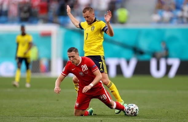 Piotr Zielinski of Poland is challenged by Sebastian Larsson of Sweden during the UEFA Euro 2020 Championship Group E match between Sweden and Poland...