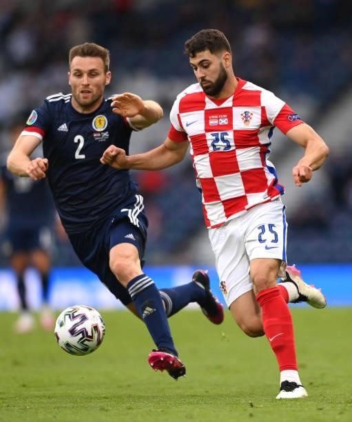 Croatia player Josko Gvardiol is challenged by Scotland player Stephen O'Donnell during the UEFA Euro 2020 Championship Group D match between Croatia...