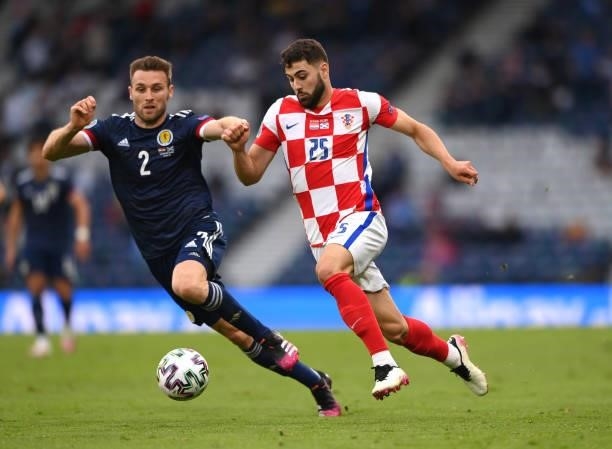 Croatia player Josko Gvardiol is challenged by Scotland player Stephen O'Donnell during the UEFA Euro 2020 Championship Group D match between Croatia...