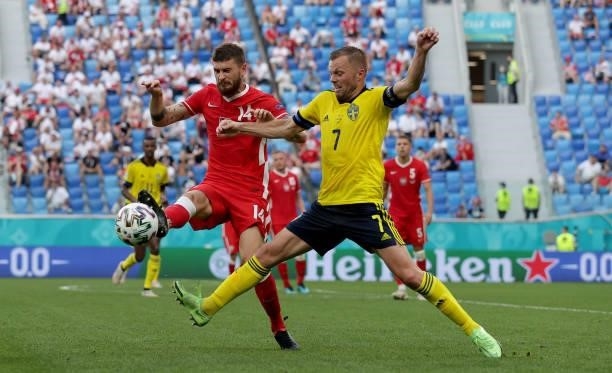 Mateusz Klich of Poland is challenged by Sebastian Larsson of Sweden during the UEFA Euro 2020 Championship Group E match between Sweden and Poland...