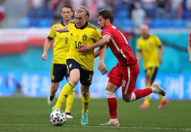 Emil Forsberg of Sweden is challenged by Bartosz Bereszynski of Poland during the UEFA Euro 2020 Championship Group E match between Sweden and Poland...