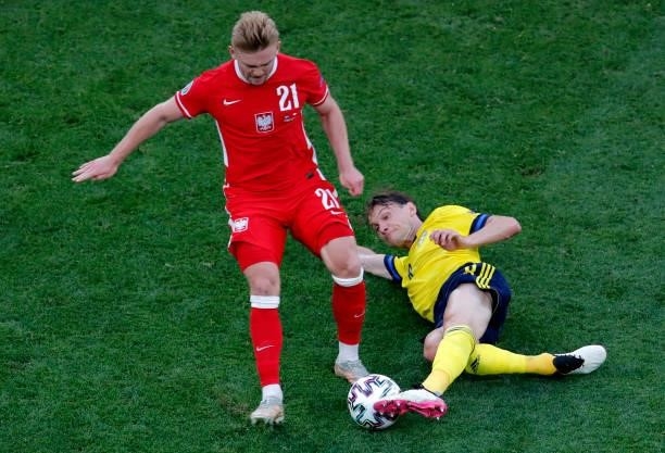Kamil Jozwiak of Poland is challenged by Albin Ekdal of Sweden during the UEFA Euro 2020 Championship Group E match between Sweden and Poland at...