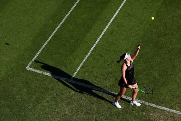 Jelena Ostapenko of Latvia serves during her first round women's doubles match with Cori Gauff of USA against Heather Watson and Harriet Dart of...