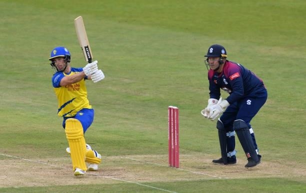 Durham batsman Sean Dickson hits out watched by Northants wicketkeeper Adam Rossington during the Vitality T20 Blast Match between Durham Cricket and...