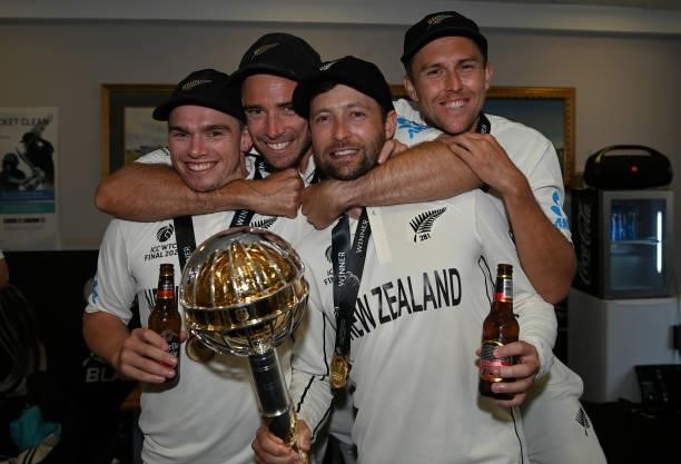 Tom Latham, Tim Southee, Devon Conway and Trent Boult of New Zealand celebrate winning in the dressing rooms after winning the ICC World Test...
