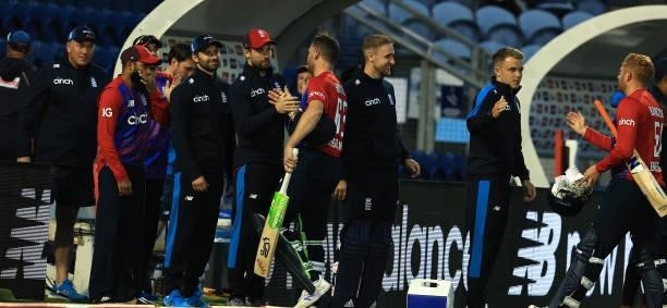 Jos Buttler of England is congratulated by team mates after scoring an unbeaten 68 runs after their victory during the T20 International Series First...