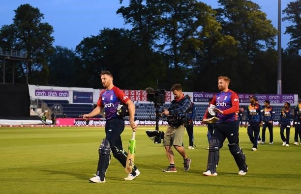 Jos Buttler and Jonny Bairstow of England make their way off following the T20 International Series First T20I match between England and Sri Lanka at...