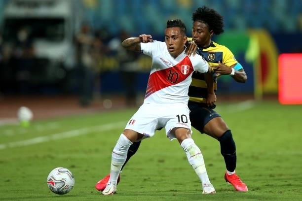 Christian Cueva of Peru fights for the ball with Angelo Preciado of Ecuador during a Group B match between Ecuador and Peru as part of Copa America...