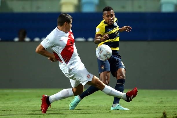 Ayrton Preciado of Ecuador kicks the ball against Aldo Corzo of Peru during a Group B match between Ecuador and Peru as part of Copa America Brazil...