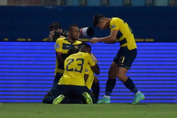 Pervis Estupiñan of Ecuador celebrates with teammates the first goal of their team scored by an own goal of Renato Tapia of Peru during a Group B...