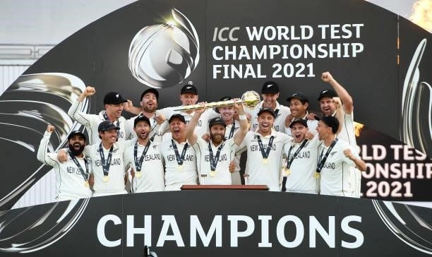 Kane Williamson of New Zealand holds the Test mace aloft with team mates after the ICC World Test Championship Final against India at The Hampshire...