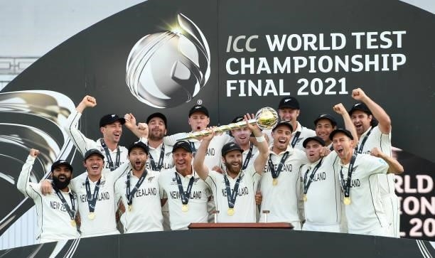 Kane Williamson of New Zealand holds the Test mace aloft with team mates after the ICC World Test Championship Final against India at The Hampshire...