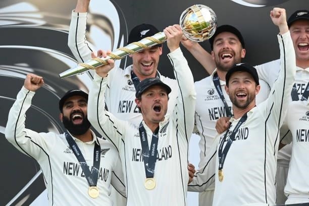 Watling of New Zealand holds the Test mace aloft with team mates Ajaz Patel and Devon Conway after the ICC World Test Championship Final against...
