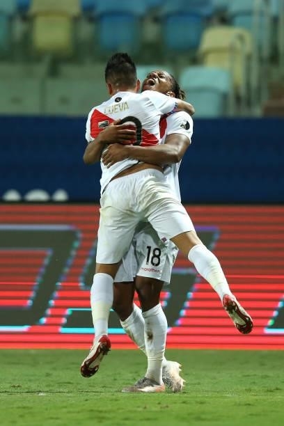 André Carrillo of Peru celebrates with teammate Christian Cueva after scoring the second goal of his team during a Group B match between Ecuador and...