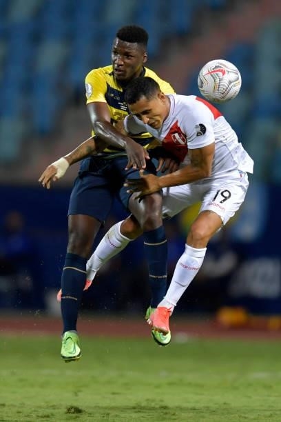Moises Caicedo of Ecuador and Yoshimar Yotún of Peru jump for the ball during a Group B match between Ecuador and Peru as part of Copa America Brazil...