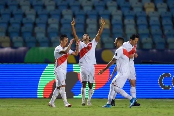 André Carrillo of Peru celebrates with teammates after scoring the second goal of his team during a Group B match between Ecuador and Peru as part of...