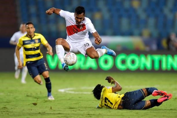 Renato Tapia of Peru jumps over Angelo Preciado of Ecuador during a Group B match between Ecuador and Peru as part of Copa America Brazil 2021 at...