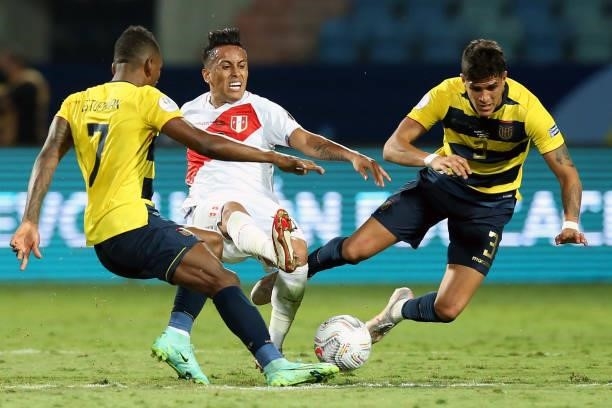 Christian Cueva of Peru fights for the ball with Pervis Estupiñan and Piero Hincapie of Ecuador during a Group B match between Ecuador and Peru as...