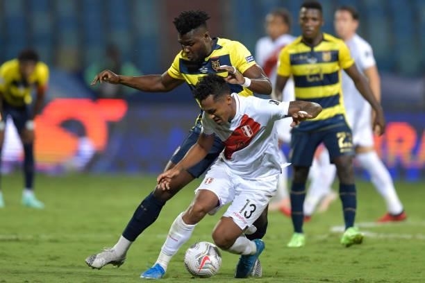 Renato Tapia of Peru fights for the ball with Jordy Caicedo of Ecuador during a Group B match between Ecuador and Peru as part of Copa America Brazil...