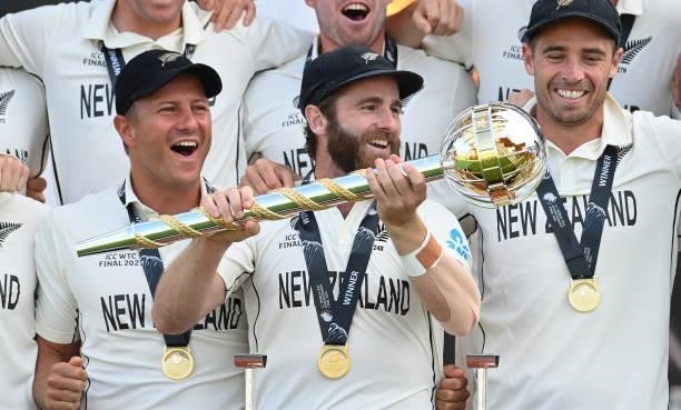 Kane Williamson of New Zealand holds the Test mace with Neil Wagner and Tim Southee after the ICC World Test Championship Final between India and New...