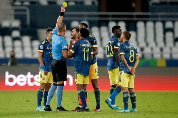 Referee Nestor Pitana shows a yellow card to David Ospina of Colombia during a Group B match between Brazil and Colombia as part of Copa America...