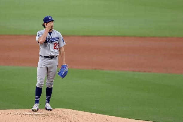 Trevor Bauer of the Los Angeles Dodgers reacts after allowing a solo homerun by Manny Machado of the San Diego Padres during the first inning of a...