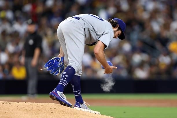 Trevor Bauer of the Los Angeles Dodgers uses a rosin bag during the third inning of a game against the San Diego Padres at PETCO Park on June 23,...