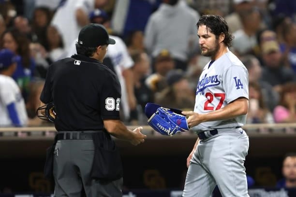 Homeplate umpire James Hoye checks the glove of Trevor Bauer of the Los Angeles Dodgers during the fourth inning of a game against the Los Angeles...