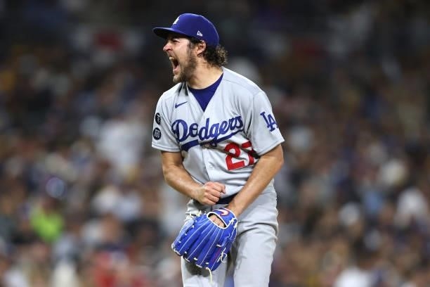 Trevor Bauer of the Los Angeles Dodgers reacts to striking out Trent Grisham of the San Diego Padres to end the sixth inning of a game at PETCO Park...