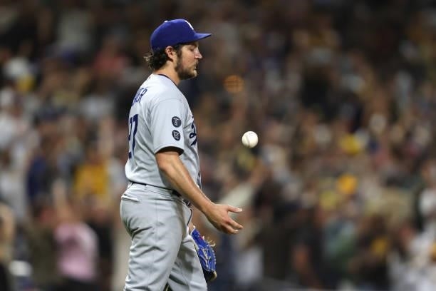 Trevor Bauer of the Los Angeles Dodgers reacts after allowing a solo homerun to Victor Caratini of the San Diego Padres during the seventh inning of...