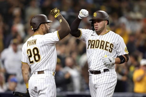 Tommy Pham of the San Diego Padres congratulates Victor Caratini of the San Diego Padres after his solo homerun during the seventh inning of a game...