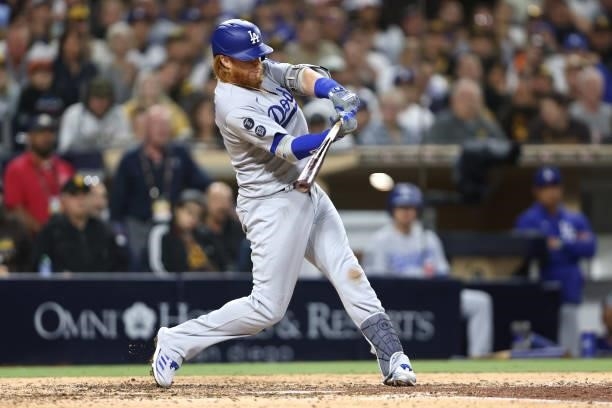 Justin Turner of the Los Angeles Dodgers connects for an RBI single during the eighth inning of a game against the Los Angeles Dodgers at PETCO Park...