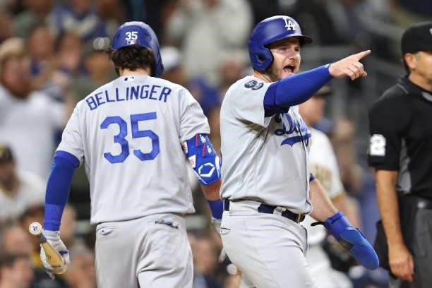Max Muncy reacts after scoring on an RBI single hit by Justin Turner of the Los Angeles Dodgers during the eighth inning of a game against the San...