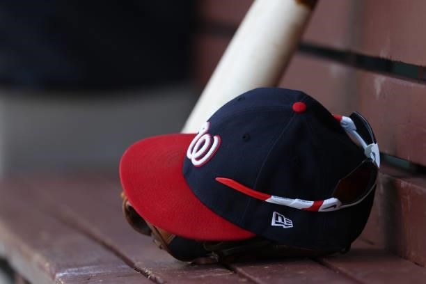 New Era Washington Nationals on the dugout bench during a game against the Philadelphia Phillies at Citizens Bank Park on June 23, 2021 in...
