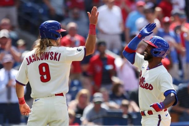 Andrew McCutchen of the Philadelphia Phillies high fives Travis Jankowski after he hits a pinch-hit grand slam home run against the Washington...