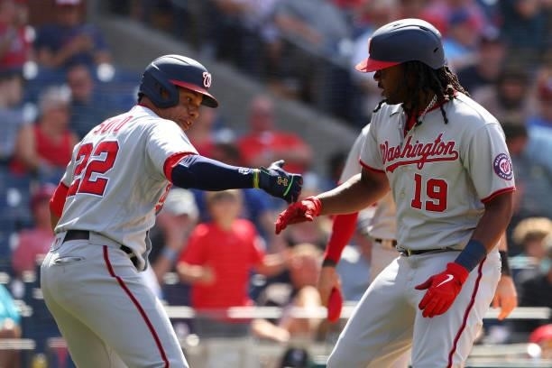 Josh Bell of the Washington Nationals celebrates with Juan Soto after he hit a grand slam home run against the Philadelphia Phillies during the sixth...