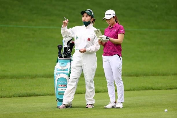 Hikari Kawamitsu of Japan talks with her coach and caddie Yumiko Yoshida during the first round of the Earth Mondamin Cup at Camellia Hills Country...
